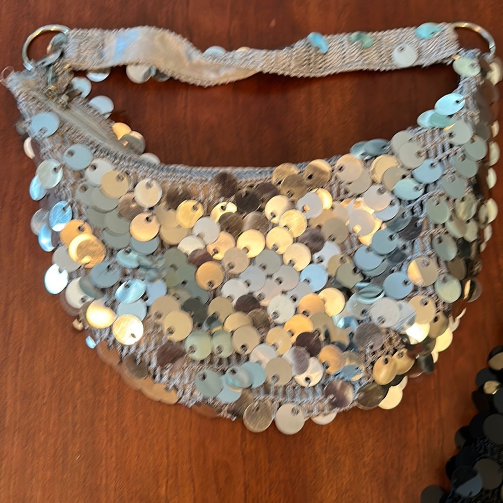 Fancy silver shoulder handbag.  Used but in good condition. No rips or stains